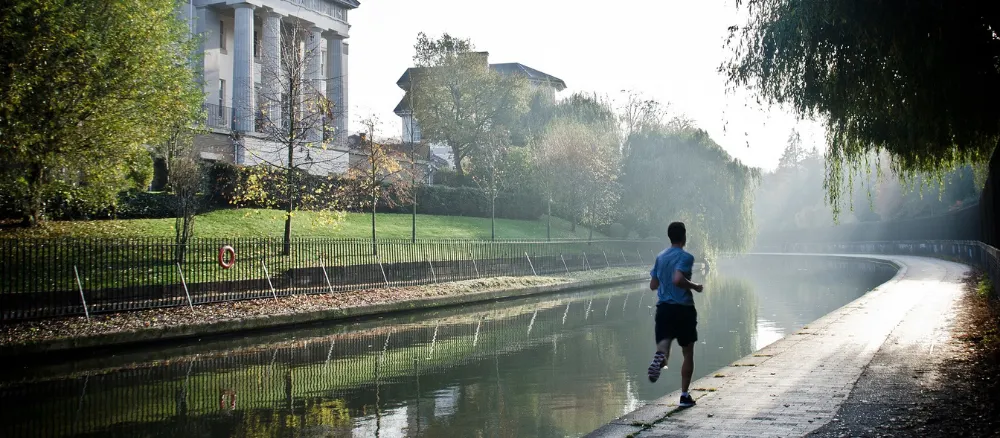 Man running outdoors next to lake to feel unstuck in Berkshire