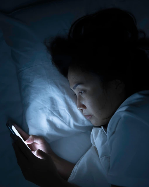 Why sleep is so important for business woman scrolling on phone